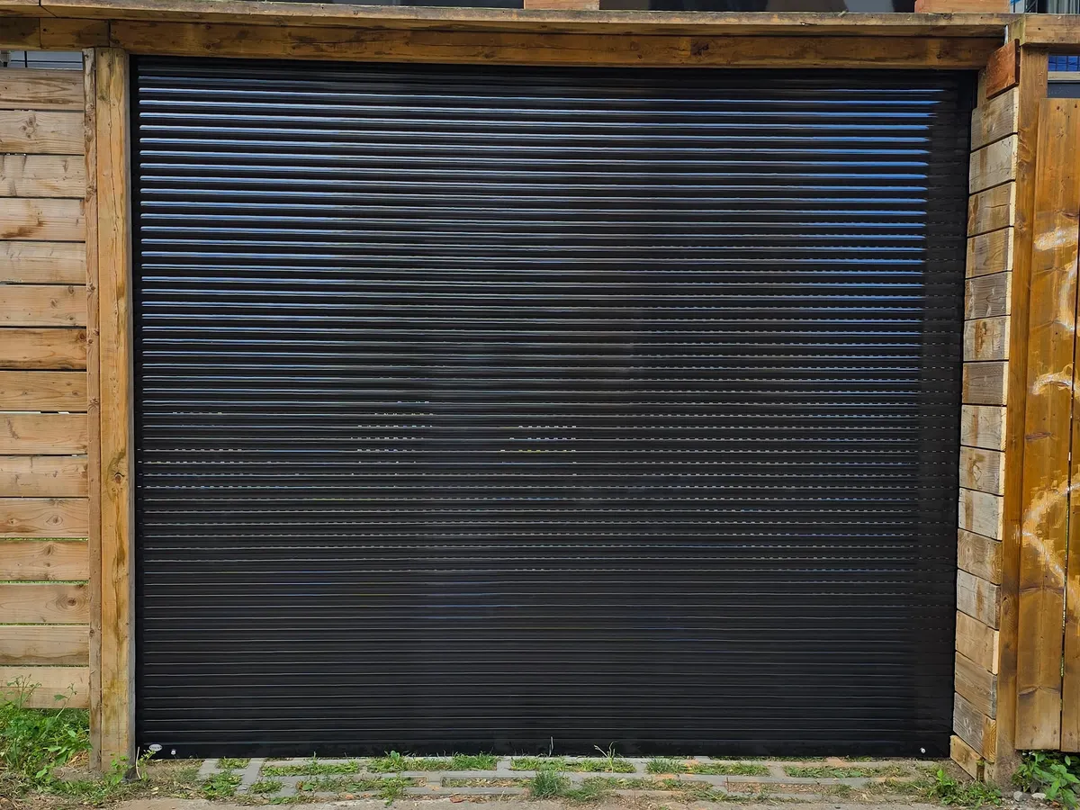 Black roll-up door in a Montreal back lane