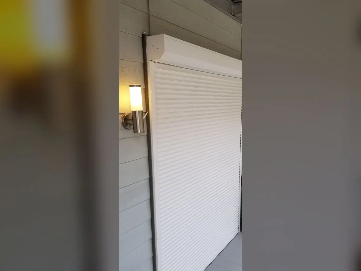 White shutter closed over a balcony door