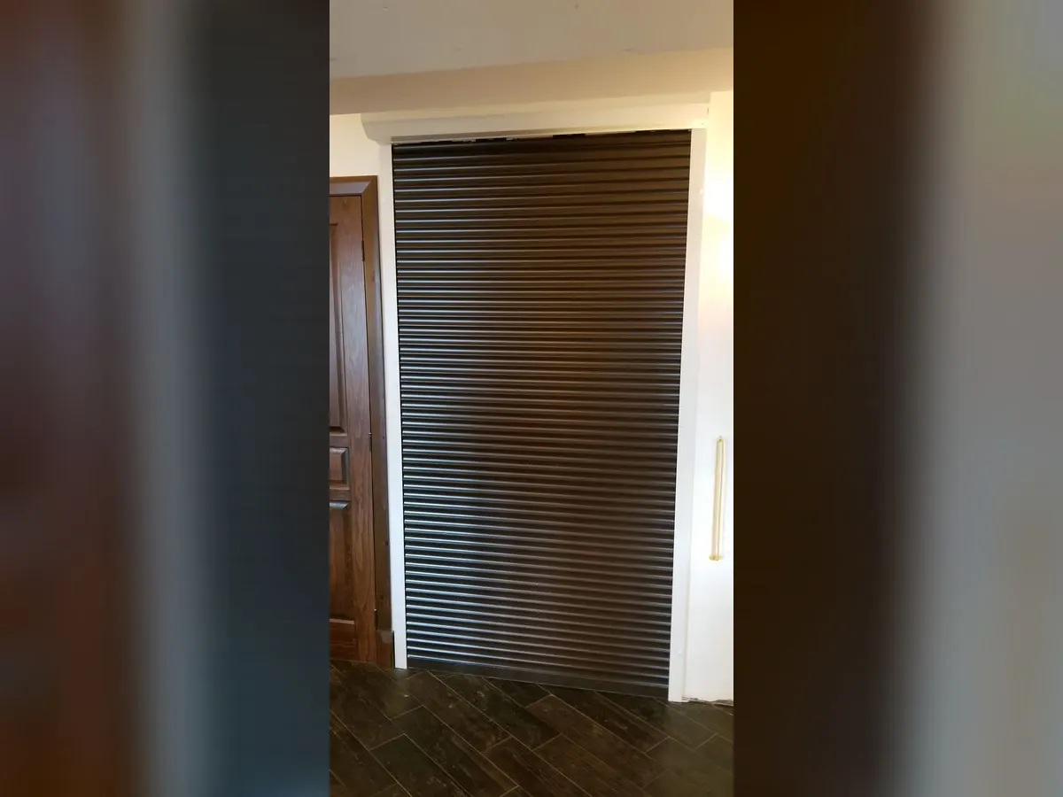 Grand volet brun fermant un accès intérieur