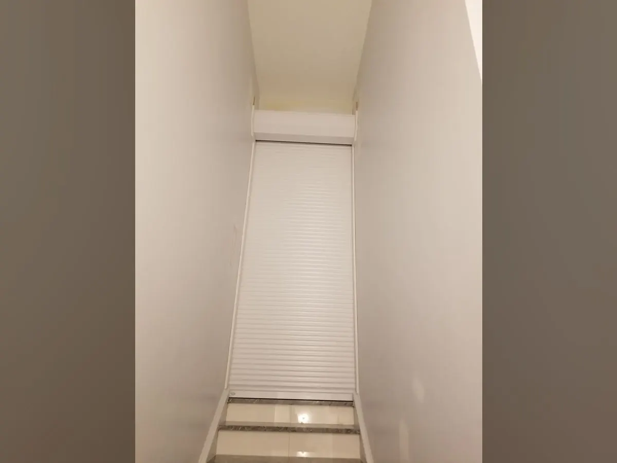 White shutter closing a stairwell