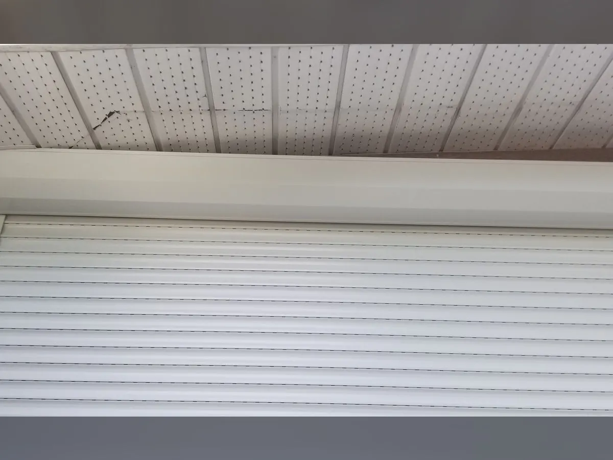 White box under a roof overhang