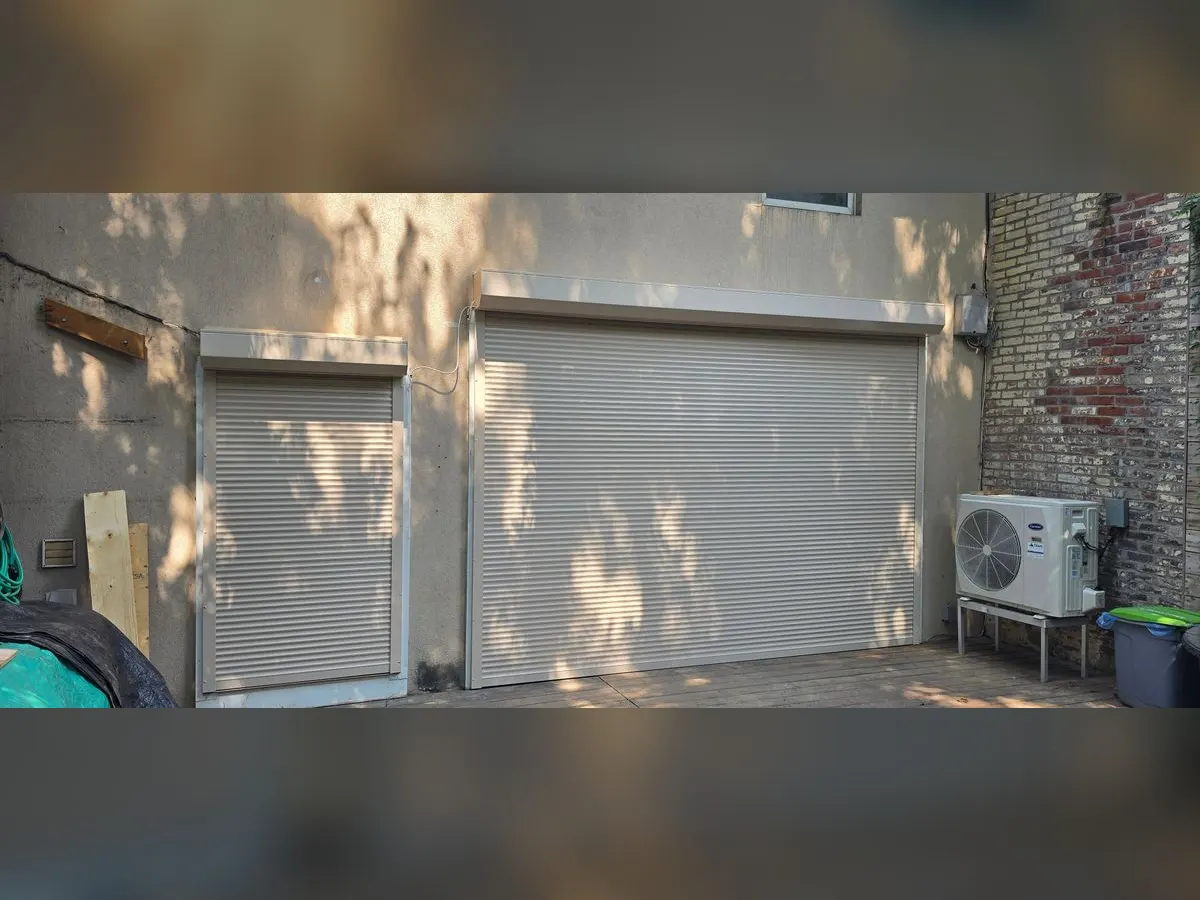 Two grey shutters in a backyard