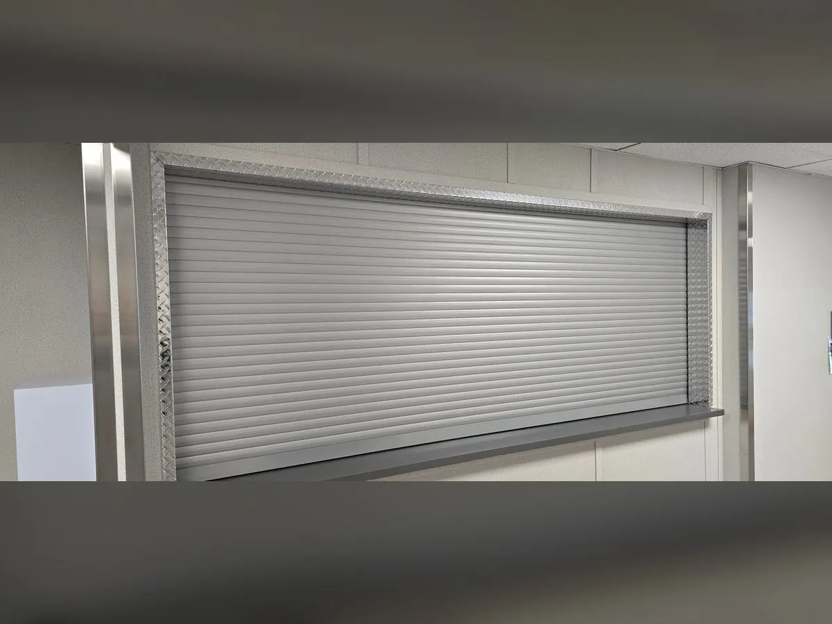 Large pass-through closed by a grey shutter