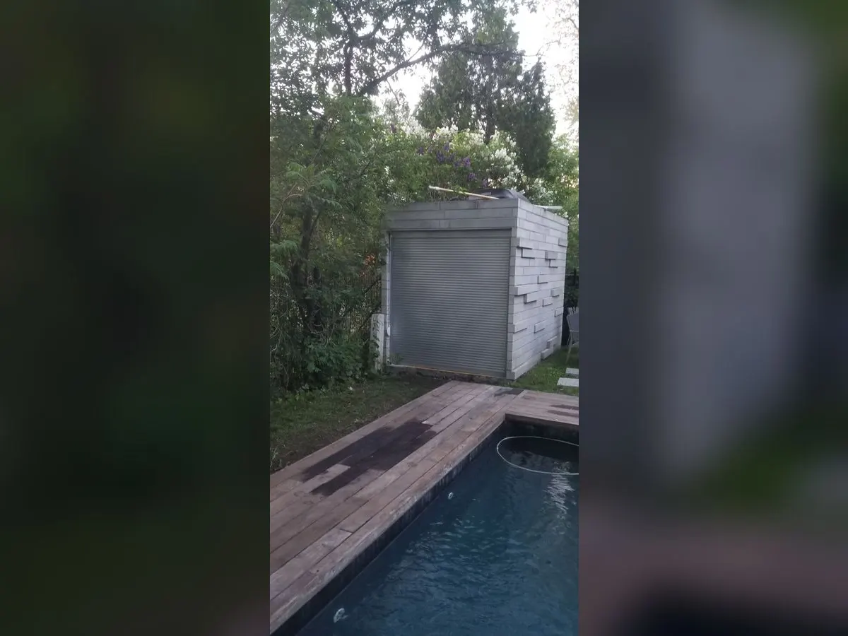Grey shutter on a pool house