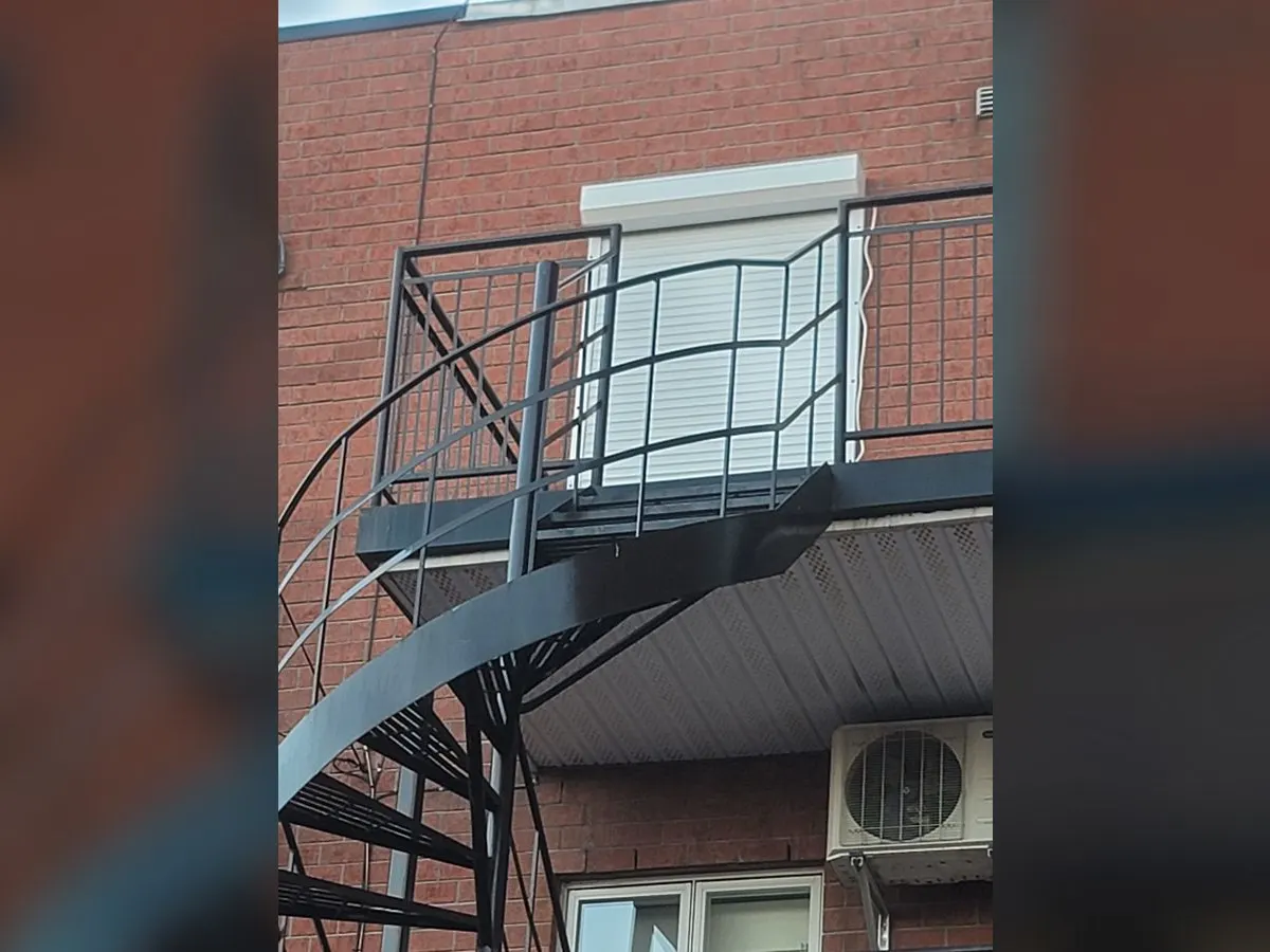 White shutter on a balcony door with an outdoor staircase