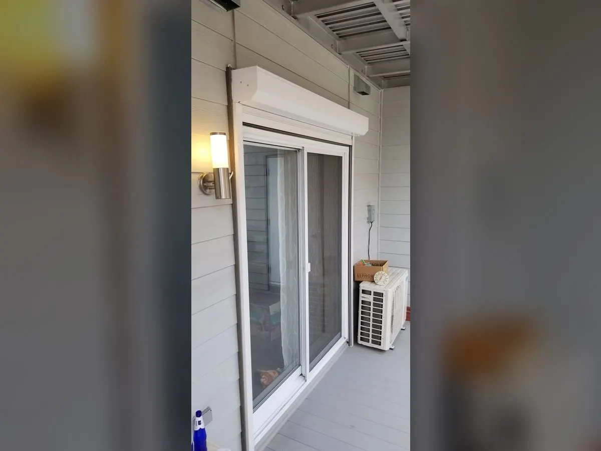 White shutter open over a balcony door
