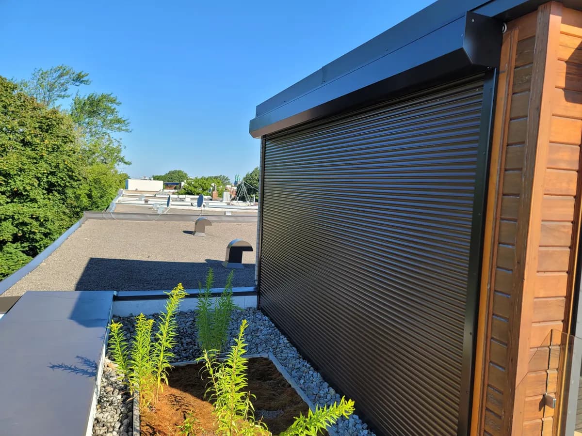 Black shutter on a rooftop terrace