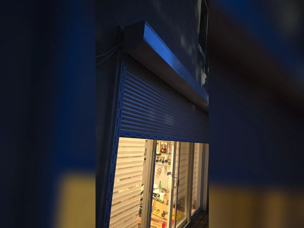 Storefront with a blue shutter, in the evening