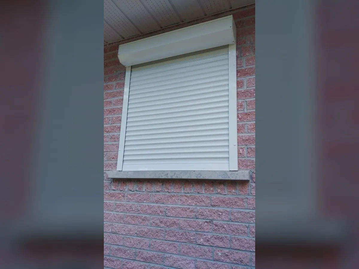 White shutter on a brick façade