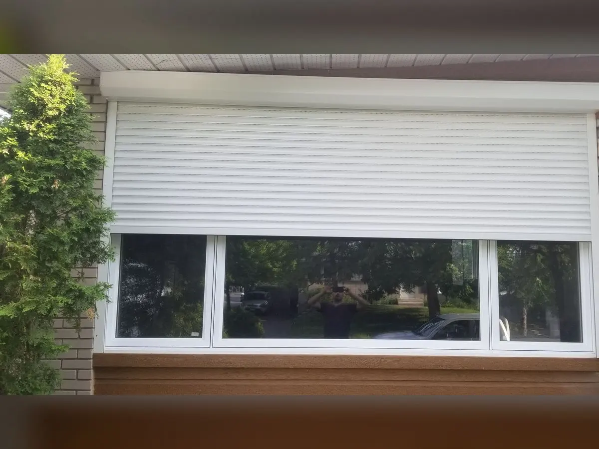 Large white shutter over a picture window