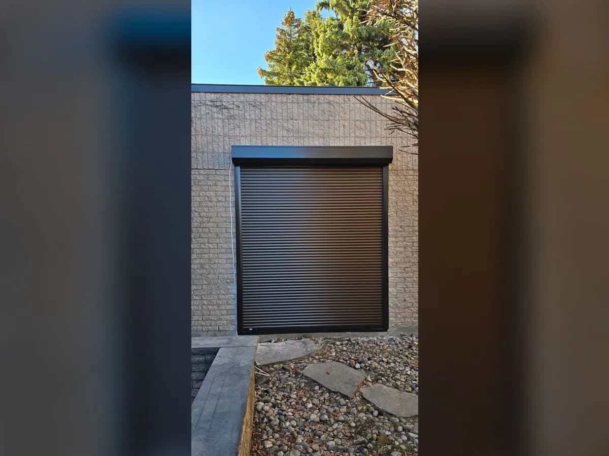 Brown shutter on a beige brick wall